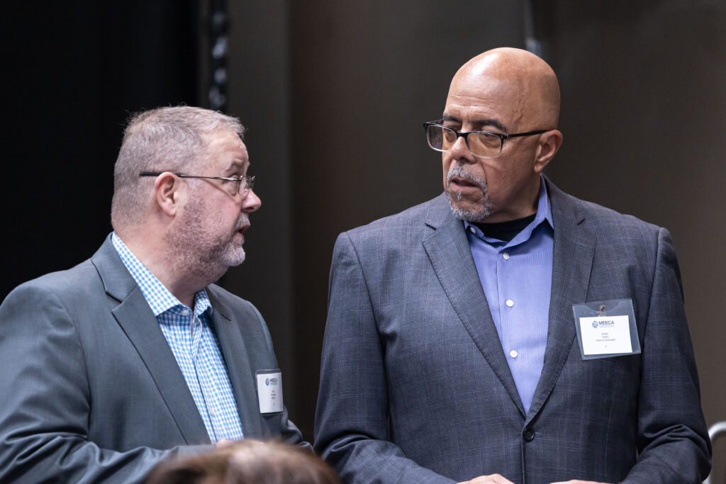 Two MEECA members in conversation at the MEECA award ceremony.