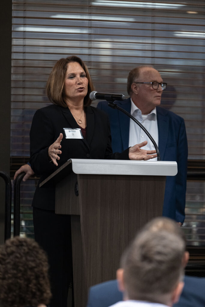 MEECA members speaking together at the podium at the MEECA award ceremony.