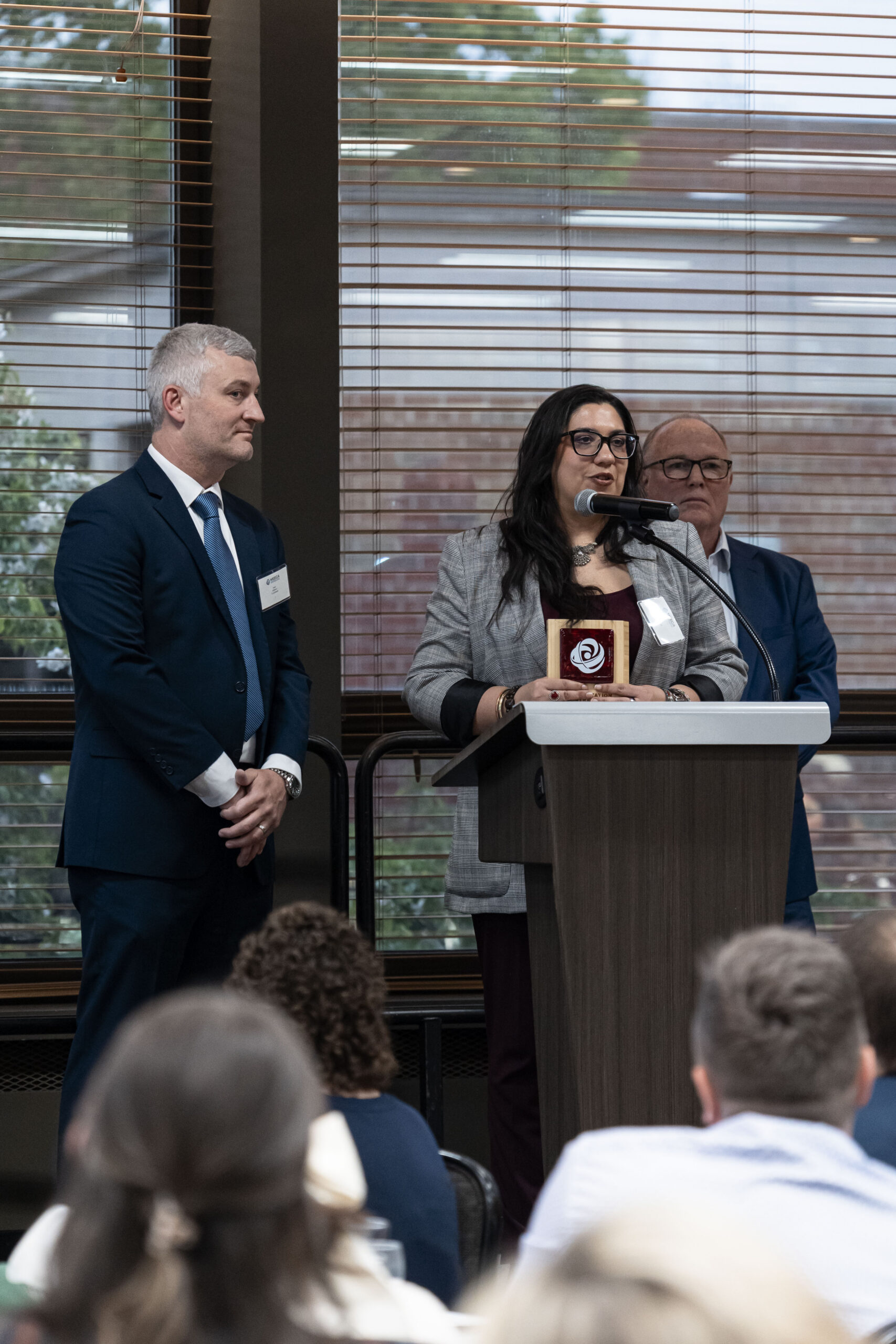 A MEECA award recipient giving acceptance remarks at the podium at the MEECA award ceremony.