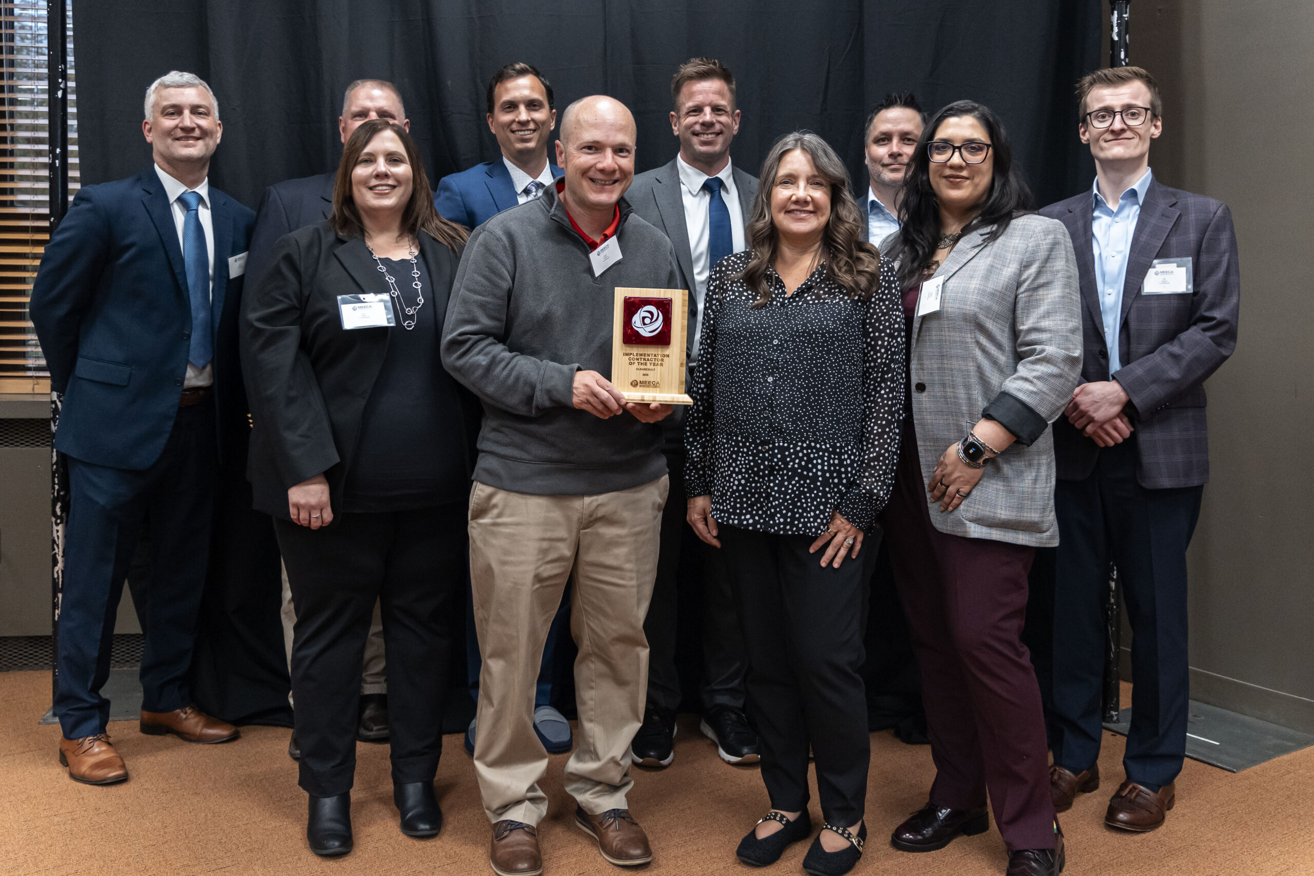 A MEECA member company team posing with their award plaque at the MEECA award ceremony.