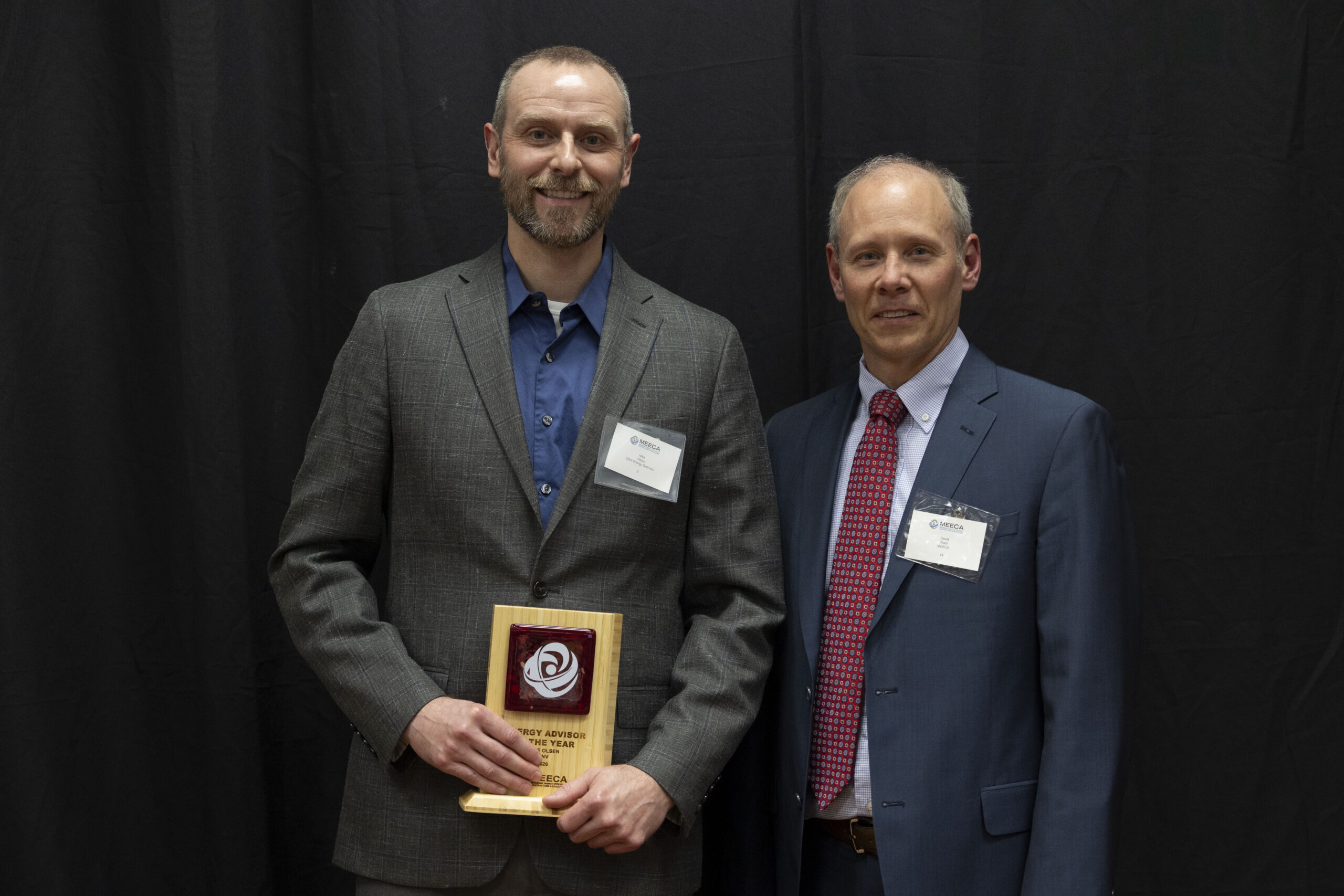 Two MEECA award recipients posing with their plaque at the MEECA award ceremony.